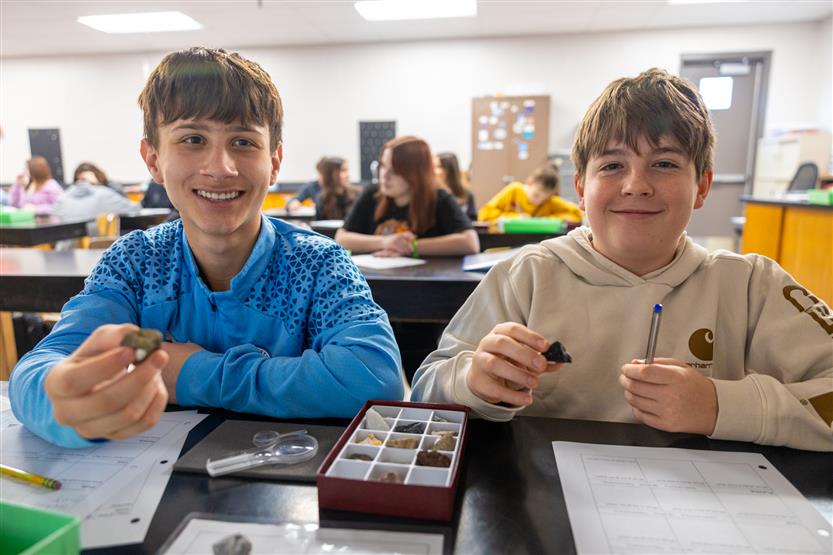 Students study rocks in a science lab
